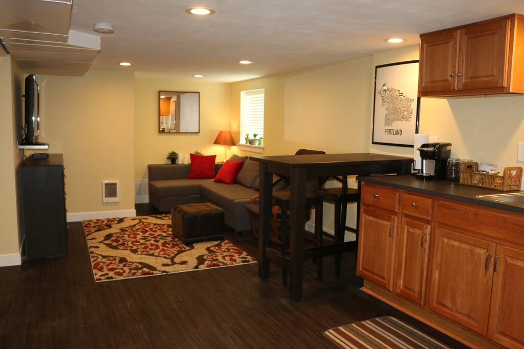 Living room and kitchen area. Couch pulls out to a queen sized bed. Flat screen TV with cable, DVD player and DVD collection