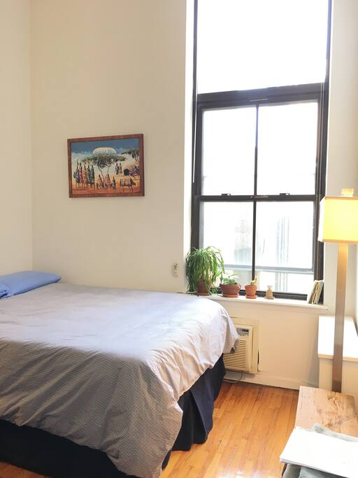 your bedroom, with a Tempur-pedic mattress and pillows, high ceilings and bright large windows