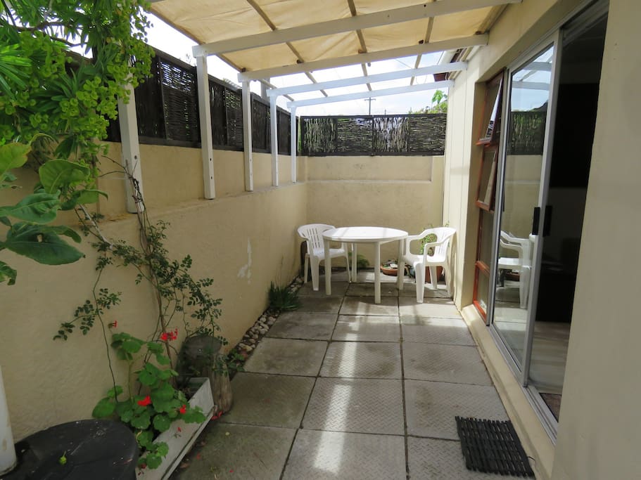 covered patio with private table and chairs