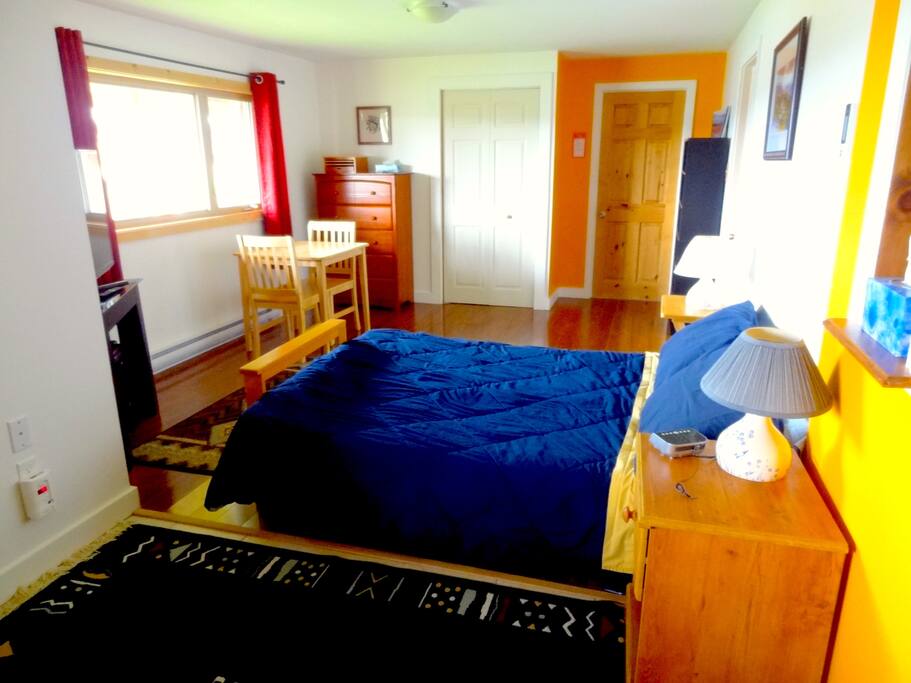 Your bedroom, with a lot of storage (chest of drawers and built-in wardrobe), a table.