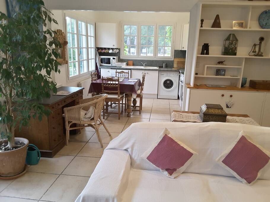 The spacious sitting-room and open plan kitchen is full of light