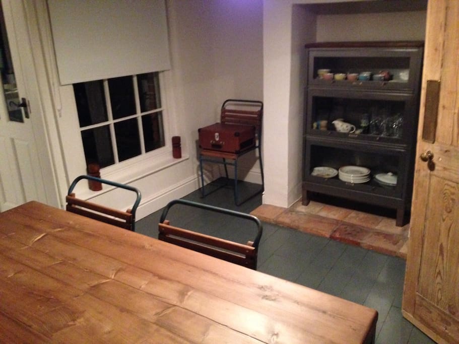 Dining room, which sits six. Well stocked cabinet with vintage crockery. Lots of books and local travel guides.