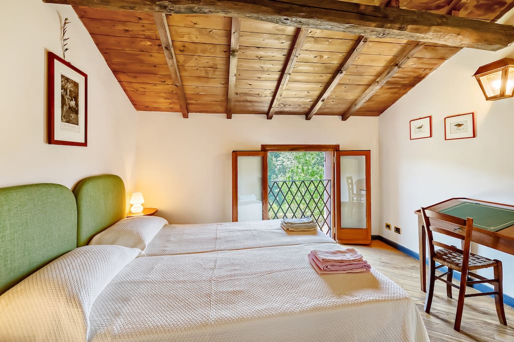 The Bedroom with the comfortable double bed with soft bed-linen and towels & the large window on the garden