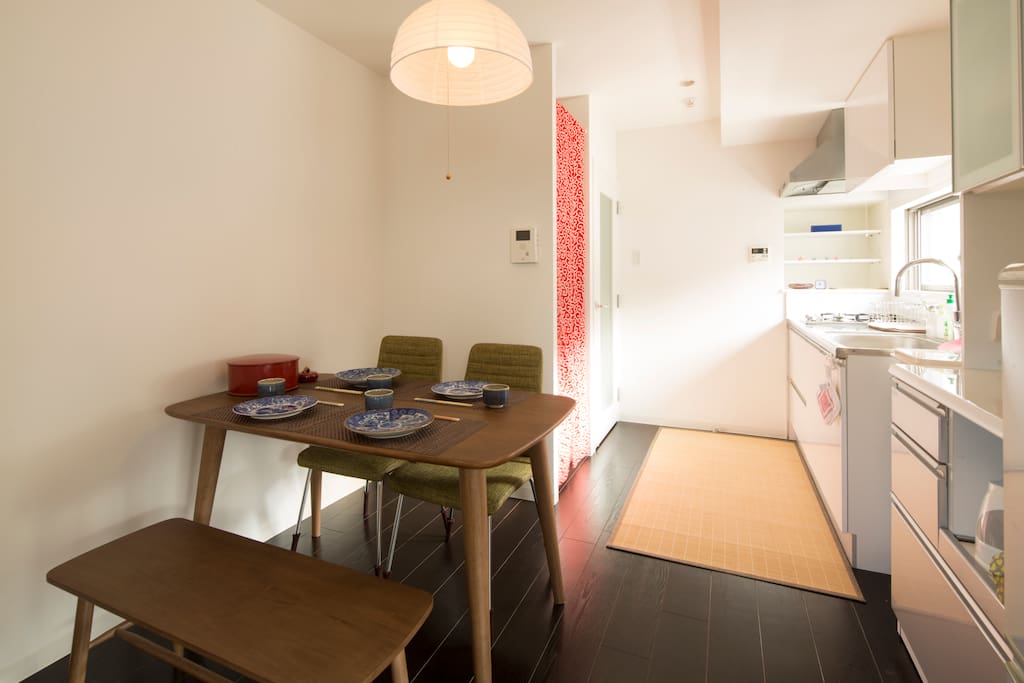 Airy dining room with washing machine and detergent for your laundry needs.