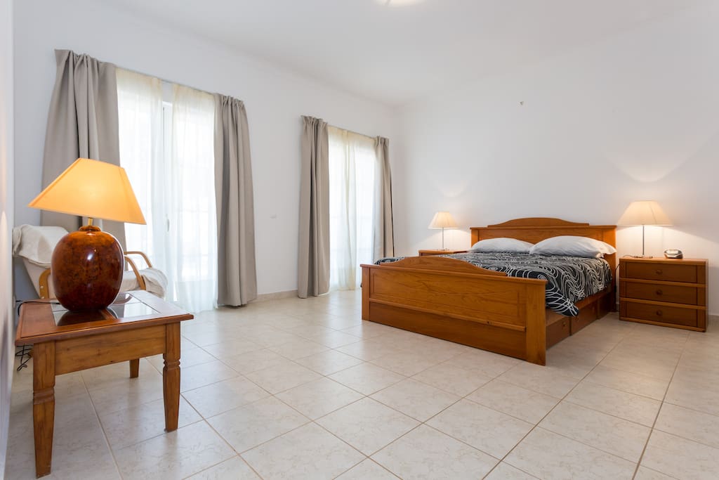 Spacious master bedroom with direct pool access