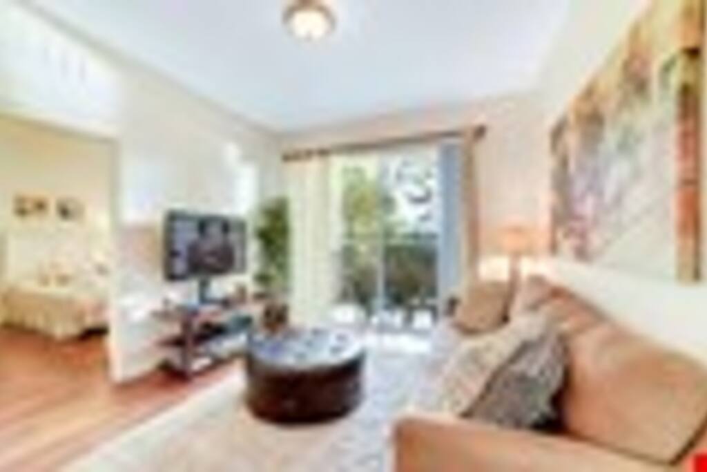 Inviting Living Area with patio access - The living room has a large HDTV, the ideal place to watch your favorite shows when you’re not out enjoying the pleasures of Orlando.