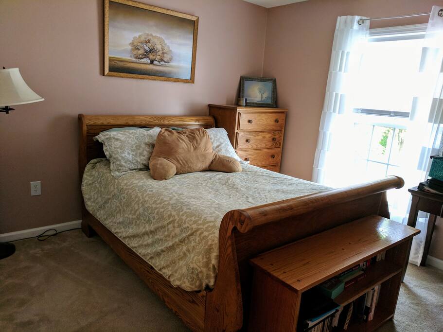 Bedroom with full-size bed, closet, and dresser.