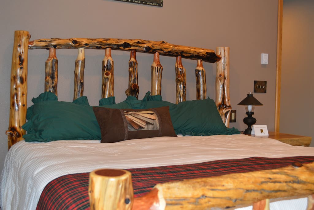 Sleep well on a King sized, pillow top mattress and custom made log bed