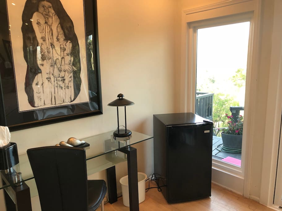 Desk and refrigerator in beautiful room with view