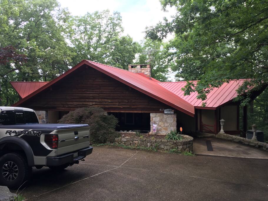 Front of the house. There is a wrap around portico that goes under the front roof line and then additional parking in front where the truck is.