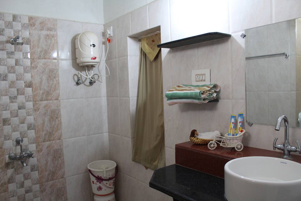 The bathroom has a geezer for hot shower.