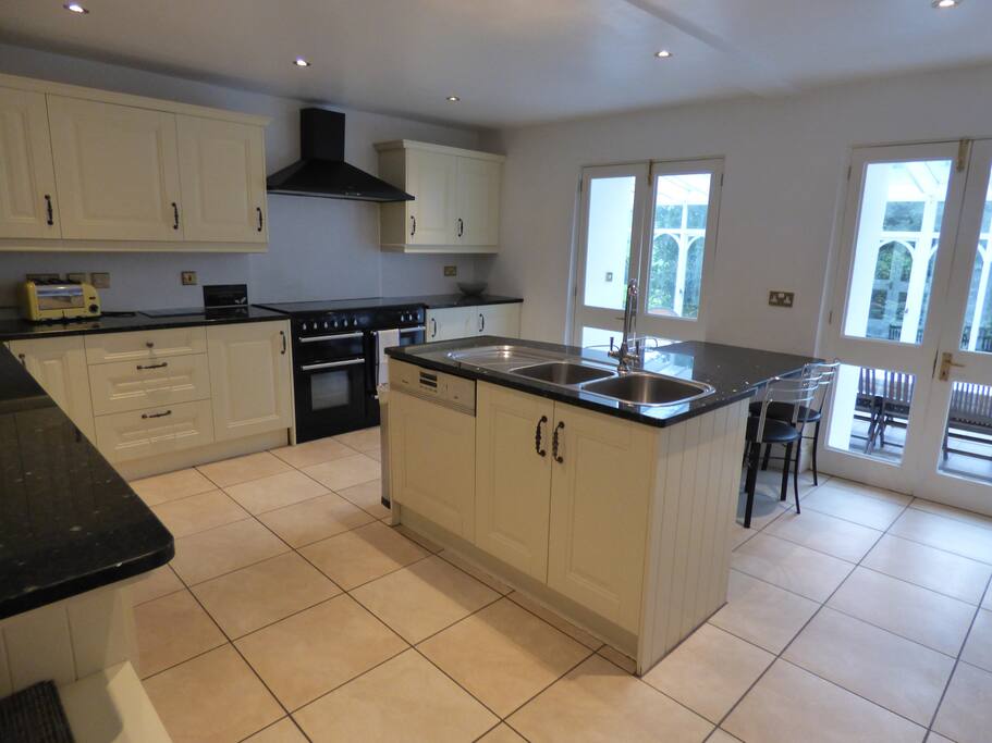 Farmhouse kitchen leading onto conservatory