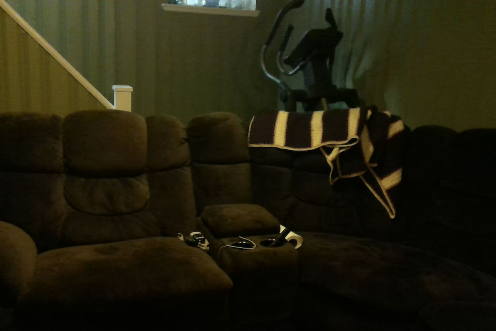 Family room has large sectional for watching movies on the big screen