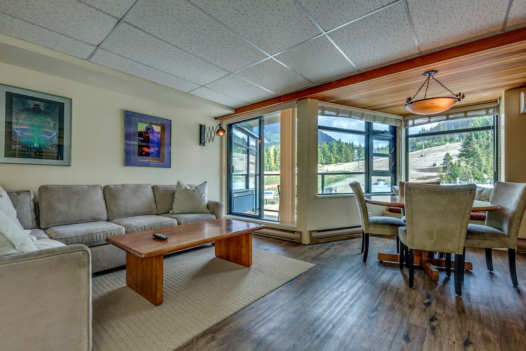 Living area with wood burning fireplace and Dining area with view of Whistler mountain