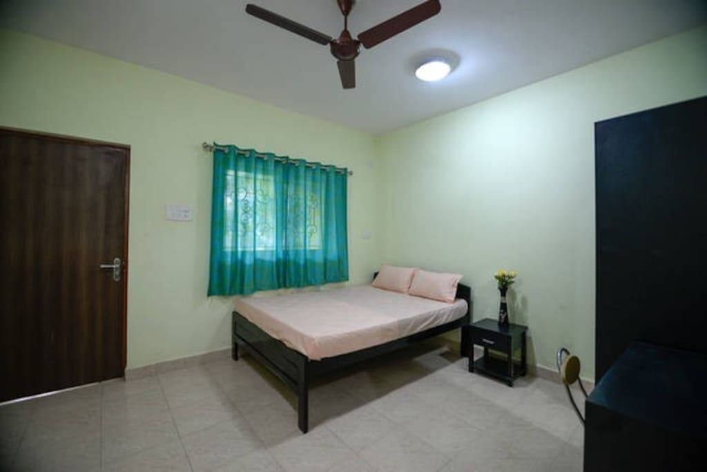 Bedroom has cupboard, sidetable, computer table