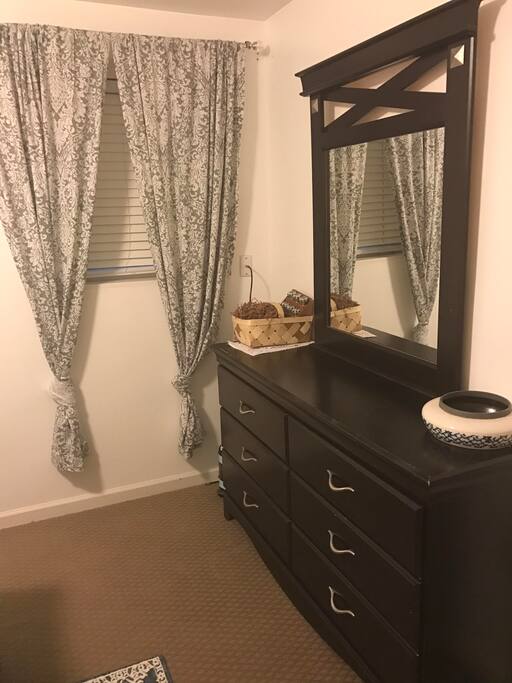 Mirror on dresser as well as full-length mirror on bedroom door. Outside light.