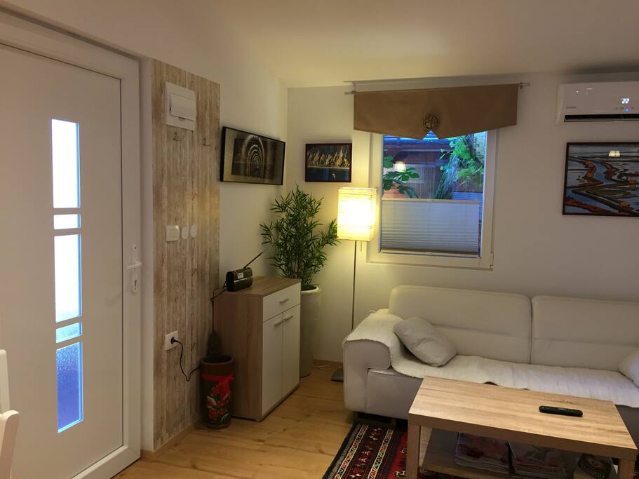 Living room with TV and air-conditioning.