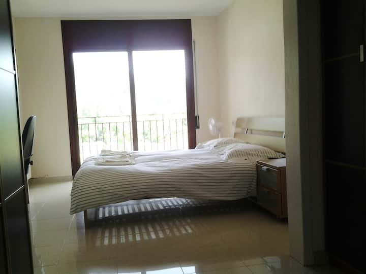 غرفة نوم رئيسية كبيرة مع شرفة وغرفة ملابس ومساحة عمل وحمام داخلي