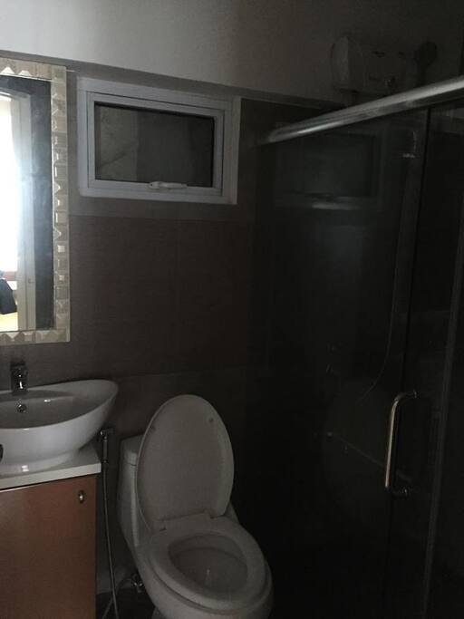 Toilet and Bath with shower heater and glass enclosure
