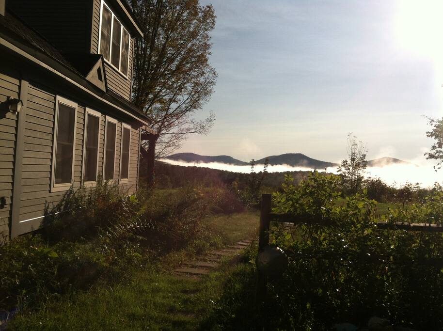The farmhouse and view off into conserved hiking lands.