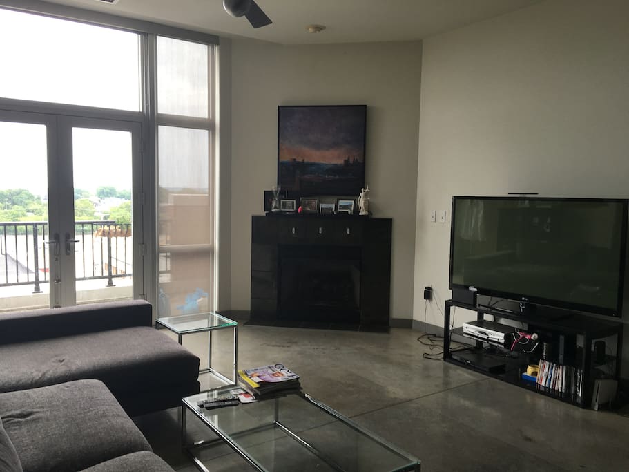 Spacious living room - equipped with 60 inch TV and access to patio facing West 25th.