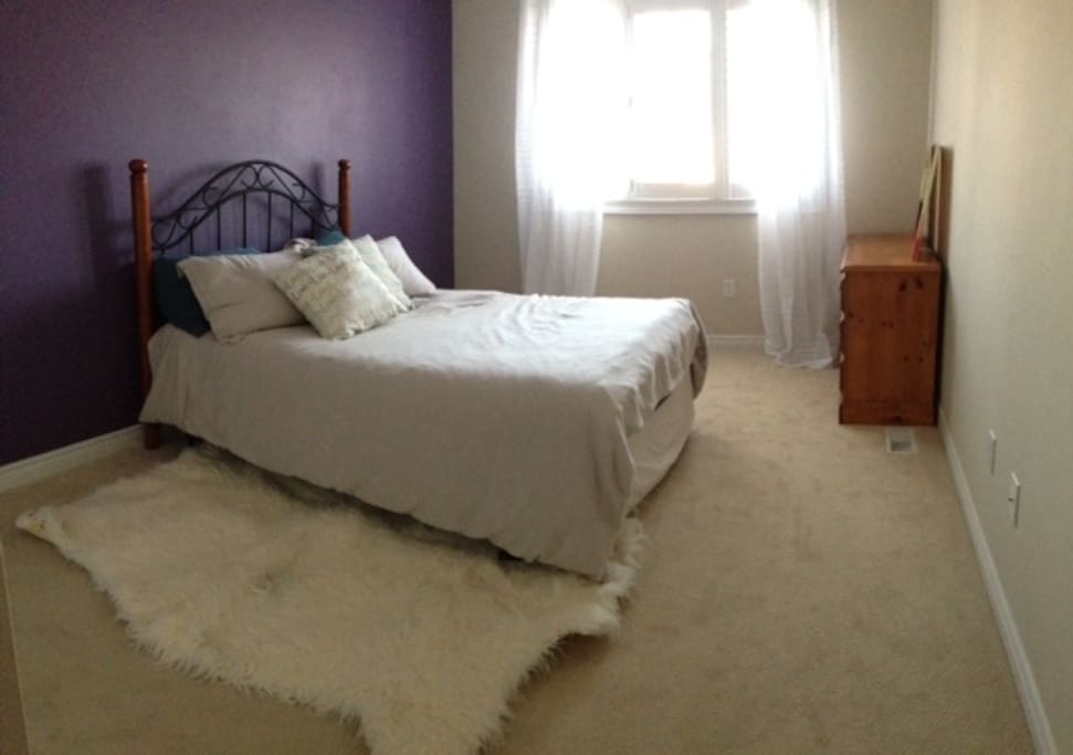 Bright and spacious bedroom with double bed, closet and dresser