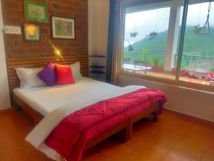 The second bedroom gets complete view of the green valley and hill and the sky too.