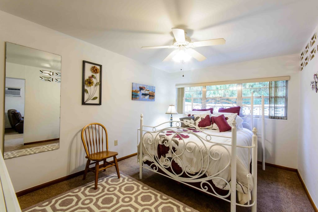 Another view of the bedroom with full length mirror showing.