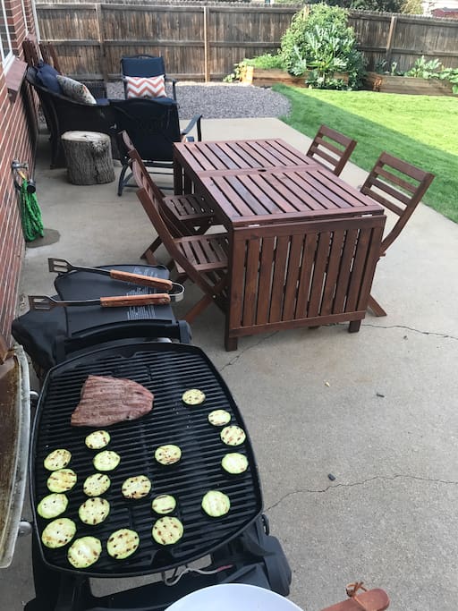 Our new backyard remodel includes outdoor seating, lights, a grill, and a garden. Guests can feel free to make a salad from our lettuce, tomatoes, and peppers - all grown with love!