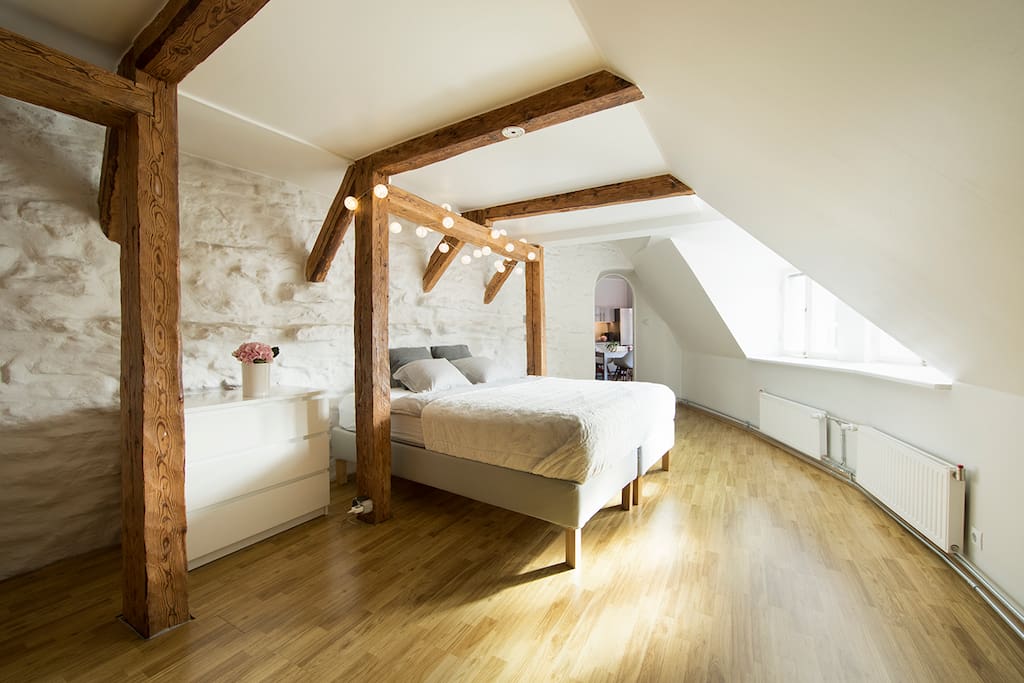 Romantic bedroom with the view over Niguliste church and old town´s red rooftops.