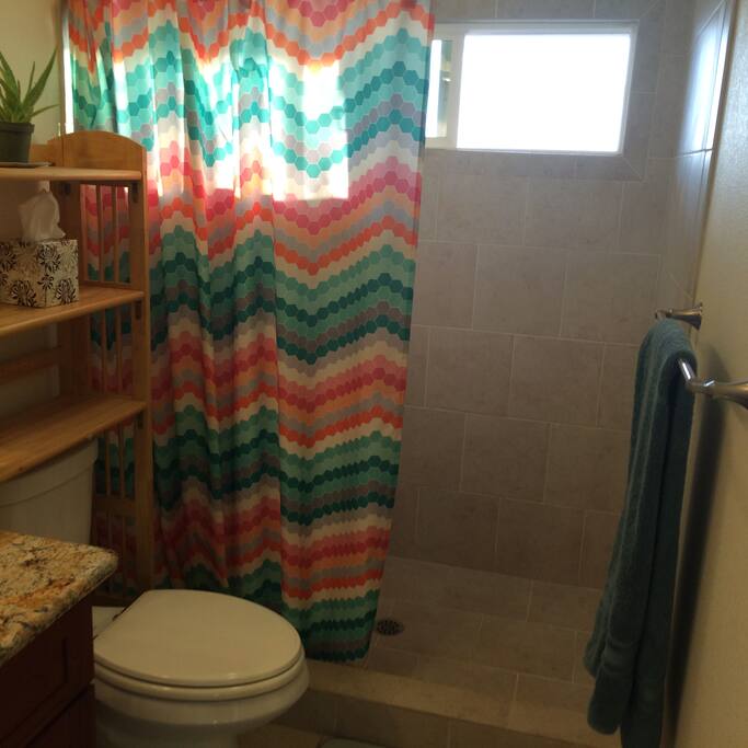 Large shower private shower stall with high window facing ocean