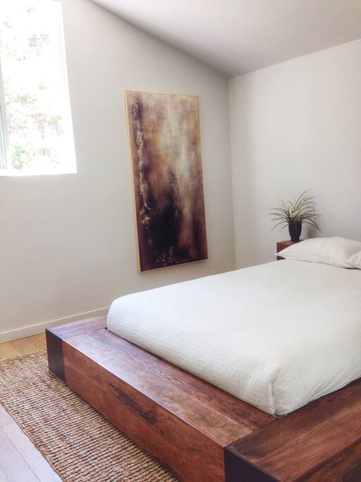 Spectacular Master Bedroom with vaulted ceilings, high bright windows, furnished with environment furniture, timothy oulton chairs, and a 65" televion