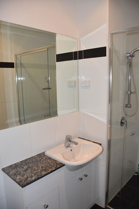 Private bathroom with shower, toilet & basin