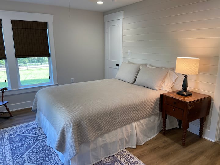 Primary bedroom with private bath. Room has a queen bed.