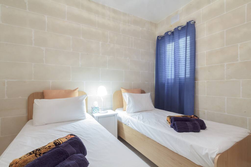 Two of the three bedrooms have two single beds