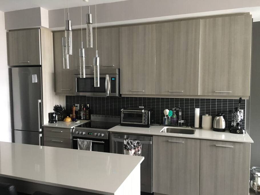 Fully stocked, modern kitchen. Comes with: pots, pans, bakeware, knives, dishes, cutlery, serving dishes, utensils, toaster, kettle, etc.