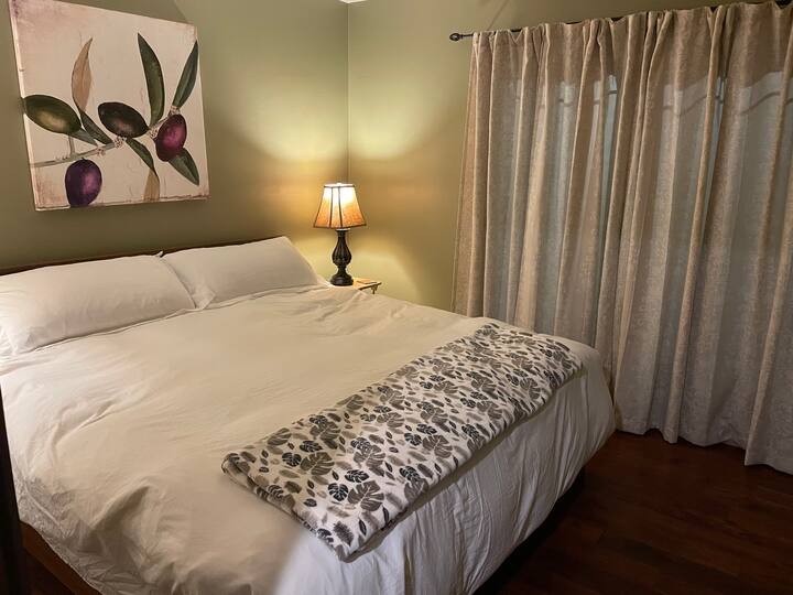 Olive suite with king bed and private walk out front patio. Shares is Jack and Jill bathroom. 