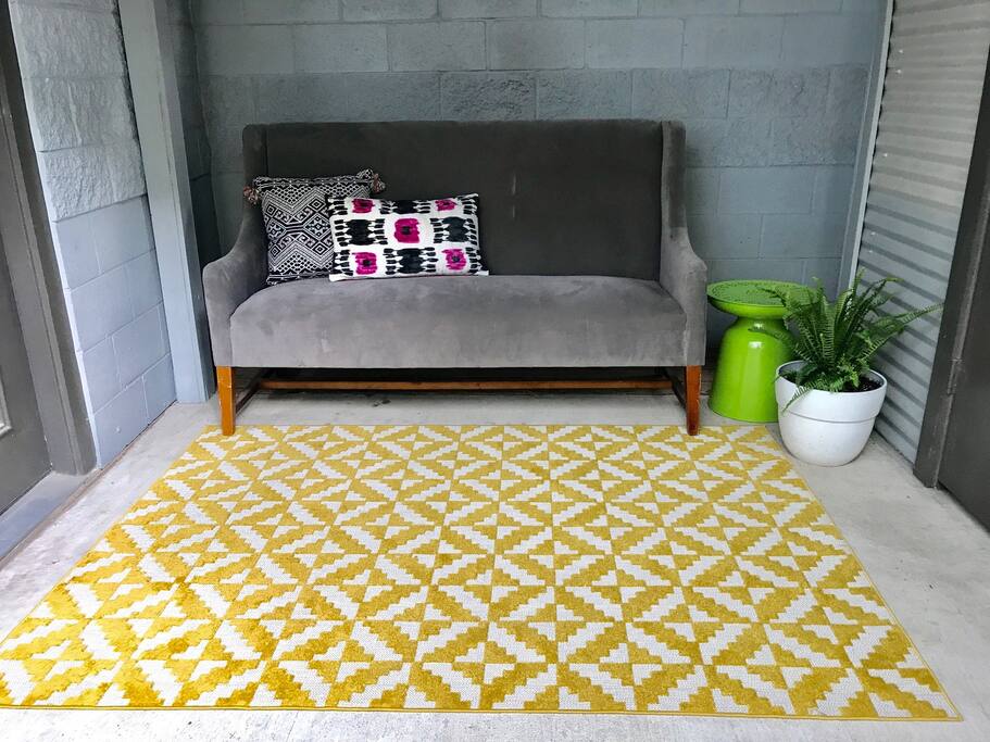 Outdoor area perfect for enjoying time outdoors under the cooling outdoor fan and lights. Surround of windows creates constant stream of natural sunlight for living area.
