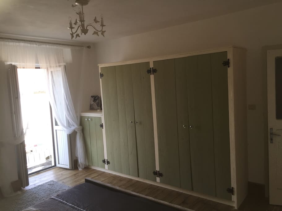 Master bedroom storage and French doors to balcony