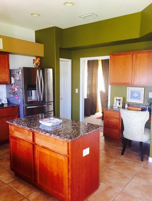 Modern appliances and your own shelve spaces, this bright kitchen also has a desk and a view of backyard, the spacious space has an island for meal preparation, here is where my son love for cooking and entertaining started, it has uninviting design and open feel...enjoy