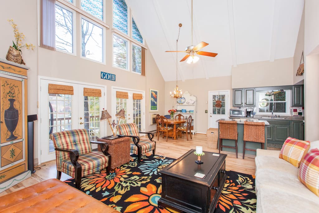 Vaulted ceilings and double-height windows feature in the impressive open living space.