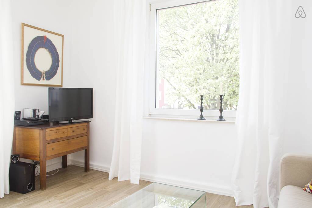 Another view from living room: good tv and large window looking out to the square
