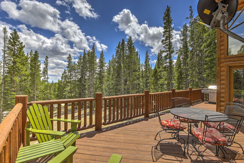 The home features a spacious, furnished deck with peaceful nature views.