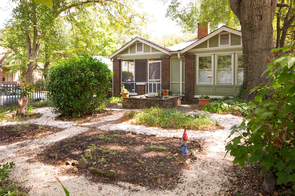 An enclosed front yard includes a small herb garden.
