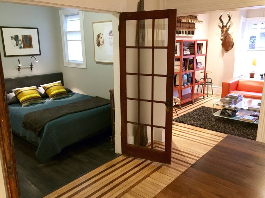 Bedroom has french doors that open up into kitchen.