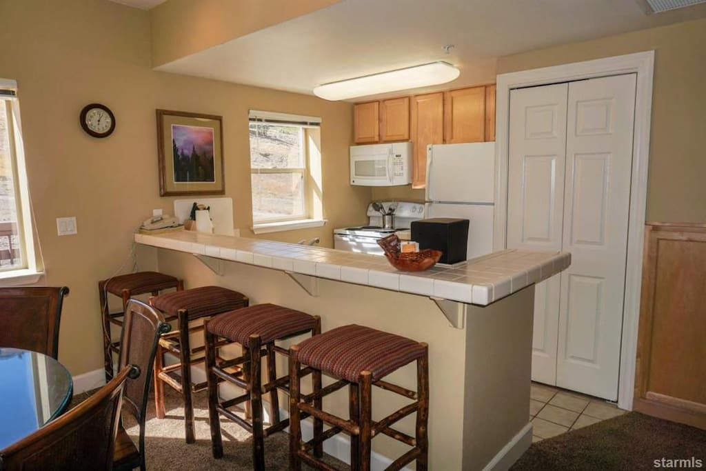 Kitchen fully stocked with washer/dryer too.