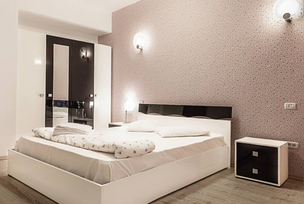 Bedroom with a king size bad, Tv and dressing.