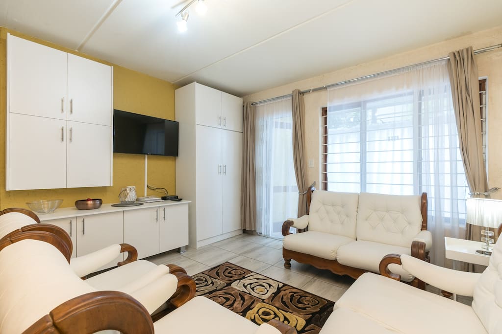Flatscreen TV, Cable, Bookcases lead out to Dining Room and Garden