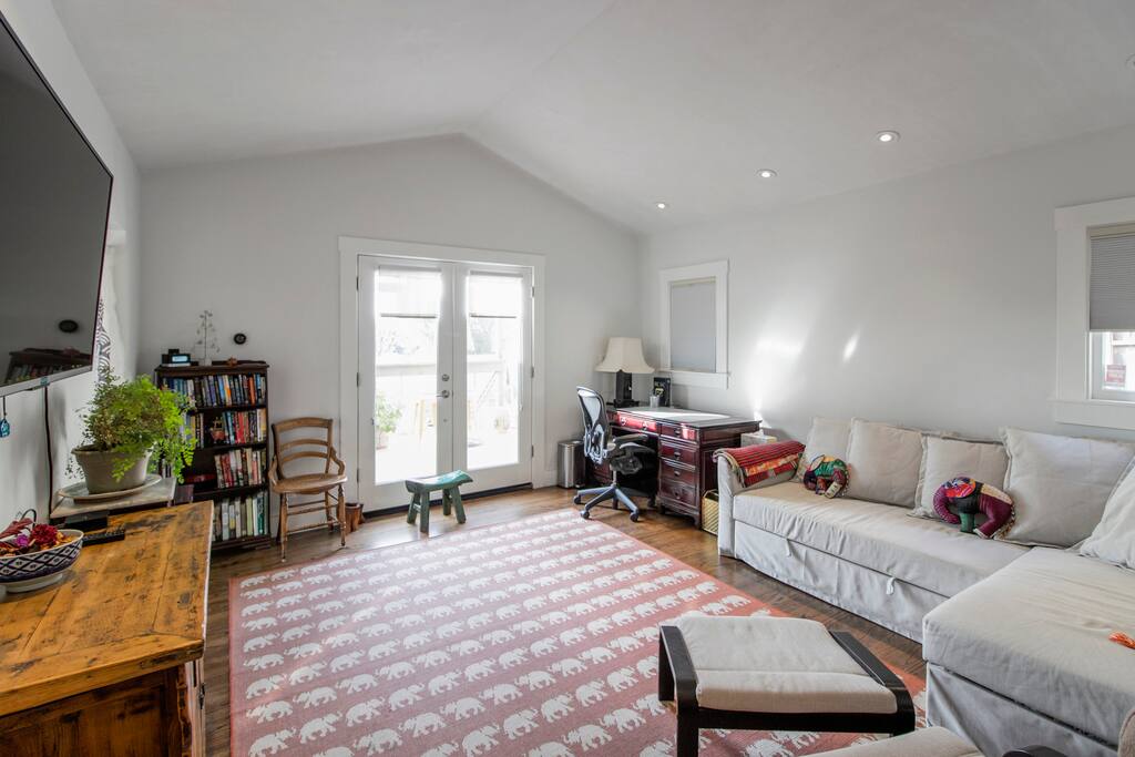 Living room with desk, comfy sofa/bed.