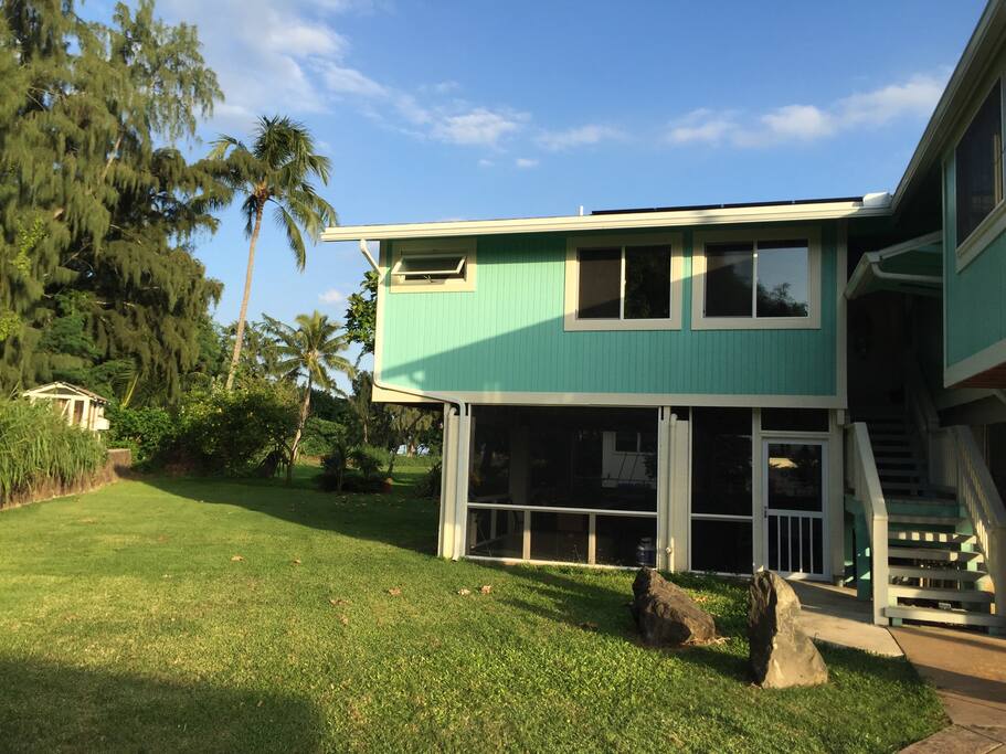 Back of house with screened in family room. Beach access through back yard 150 yards to quiet beach.